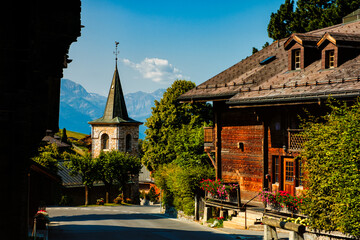 Street view in the picturesque municipality of Leysin, canton of Vaud near Aigle, Switzerland on bright sunny day in summer - obrazy, fototapety, plakaty