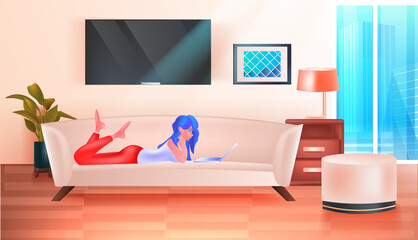 woman lying on sofa and using laptop social media network online communication relaxation concept