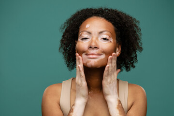 Smiling young african woman doing self massage