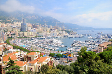 Fototapeta na wymiar Panoramic view of Monte Carlo harbor in Monaco. Port Hercules. Yachts in the port. Aerial view, cityscape.