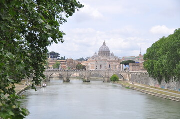 Amazing view of The Papal Basilica of Saint Peter behind Ponte Sant'Angelo on Tyber river, Rome, Italy