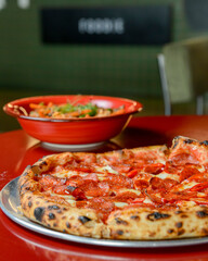 Hot Chilli Pepperoni Pizza, ready to eat. Whole sliced pepperoni salami pizza with red hot pepper