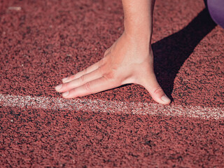 Female wrist with outstretched fingers at the starting line