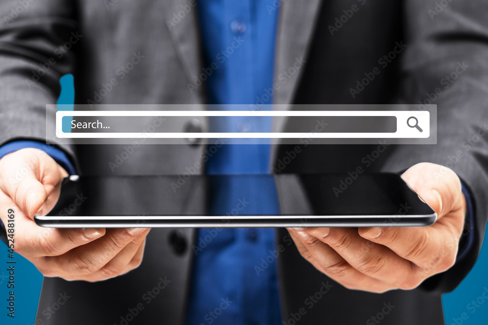 Poster businessman hand holding tablet with creative website search bar hologram on blue background. intern