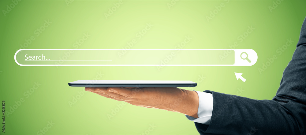 Poster businessman hand holding tablet with creative website search bar hologram on green background. inter
