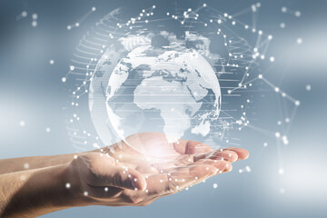 Close up of male hands holding abstract glowing polygonal globe on blurry background. Network, communication and global innoovation concept.