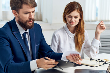 colleagues sitting at the table in front of laptop professionals technology
