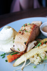 tasty salmon, mash potato and vegetable on plate 