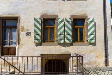Close-up of windows and wooden shutters at medieval house at the old town of Nyon. Photo taken August 11th, 2021, Nyon, Switzerland.