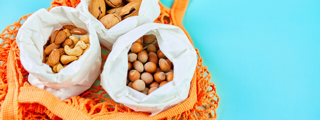 Top view of various sort of nuts on the table in a paper bag in shopping grocery