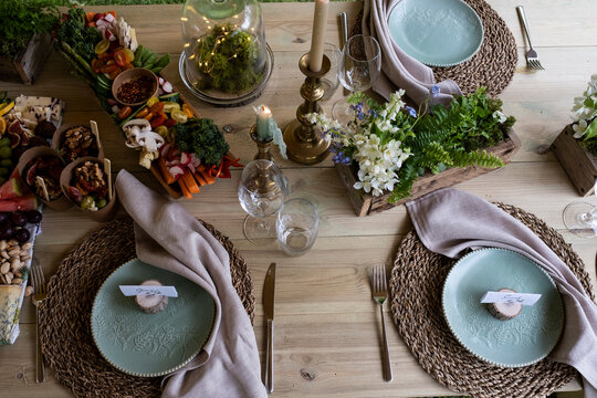 High angle close up of rustic place setting for a woodland naming ceremony.