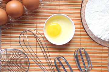 Baking ingredients on a black background, top view.