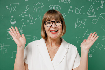 Smiling cheerful clever teacher mature elderly lady woman 55 wear shirt glasses spreading hands...