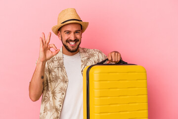 Young caucasian man with tattoos going to travel isolated on pink background  cheerful and...