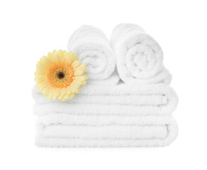 Obraz na płótnie Canvas Fresh clean towels with gerbera on white background