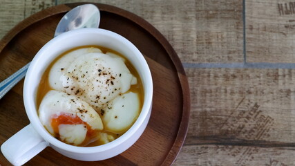 Boil eggs in a white coffee mug.