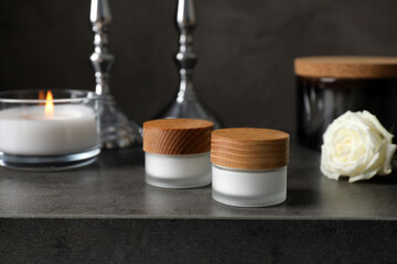 Jars with cream on black table. Cosmetic product