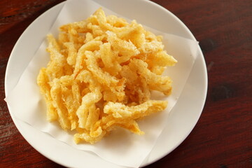 The top view of Delicious golden yellow crispy fish maw is Asian food and snack.