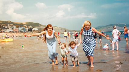 Multigenerational family is joyful and reunited during their summer holidyas in Lyme Regis, United...