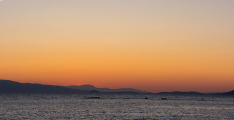 sunset on the sea over the port in Aegina in Greece