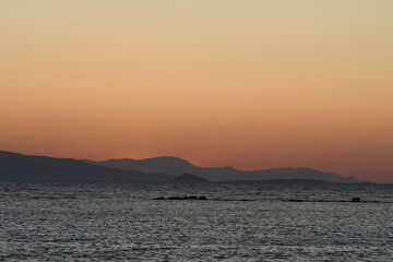 Fototapeta premium sunset on the sea over the port in Aegina in Greece