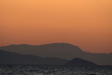 sunset on the sea over the port in Aegina in Greece
