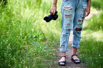 Woman photographer with a photo camera in hand outdoor