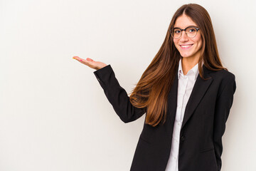 Young caucasian business woman isolated on white background showing a copy space on a palm and holding another hand on waist.