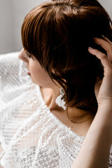 Fototapeta premium A girl in a white negligee near the bath