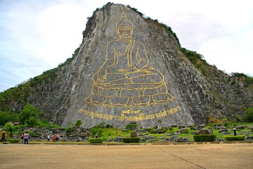 Buddha image engraved into the rock face using lasers outlined using gold