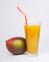 Tropical mango exotic fruit and juice in glass on the white