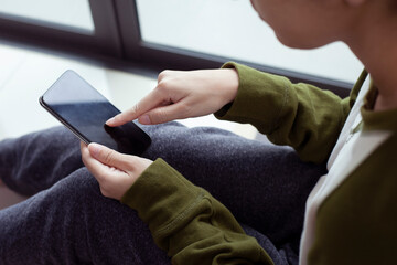 Closeup woman hand touch screen on smart phone, marketing technology and business concept.