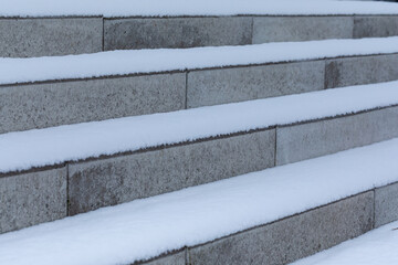 snow on granite steps in the park