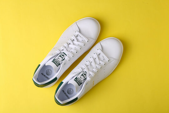 Jeddah Saudi Arabia  August 21 2021  ADIDAS stan smith endorsed by shoes, on yellow background. Product shot. Adidas is a German corporation that designs and manufactures sports shoes