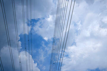 Blue sky and clouds. Beautiful cloudscape over horizon Beautiful landscape with shiny light blue skyHigh voltage transmission substation on dark blue sky background, industrial aerial photography