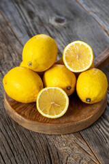 Fototapeta na wymiar fresh ripe lemons on wood background