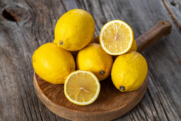 fresh ripe lemons on wood background