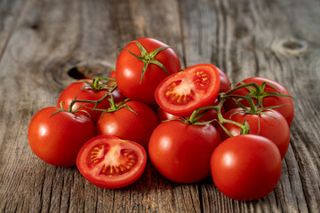 fresh ripe bunch tomatoes on wood background