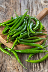 fresh ripe green pepper on wood background