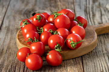 fresh ripe cherry tomatoes on wood background. Close up
