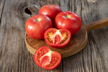 fresh ripe tomatoes on wood background