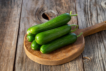fresh ripe cucumbers on wood background