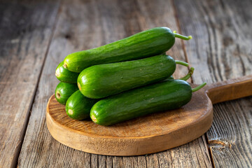 fresh ripe cucumbers on wood background. Close up