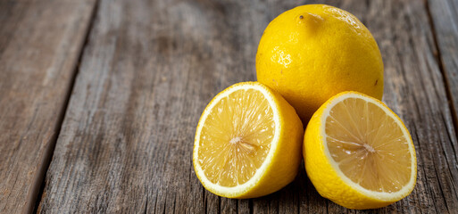 Fototapeta na wymiar fresh ripe lemons on wood background. Copy space