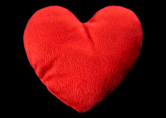 A soft, cute, romantic heart-shaped plush, isolated on a black background.

