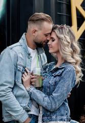 a stylish couple in denim clothes hugs