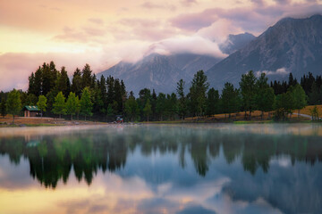 Cloudy Sunrise Over Quarry Lake And Mountains