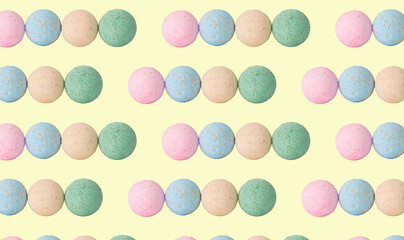 Creative pattern fashion photo of cosmetics beauty products bath bombs on a yellow background