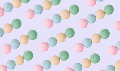 Creative pattern fashion photo of cosmetics beauty products bath bombs on a violet background