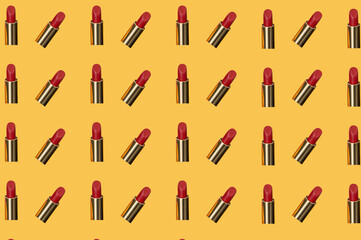 Creative pattern fashion photo of cosmetics beauty products red lipstick on a orange background